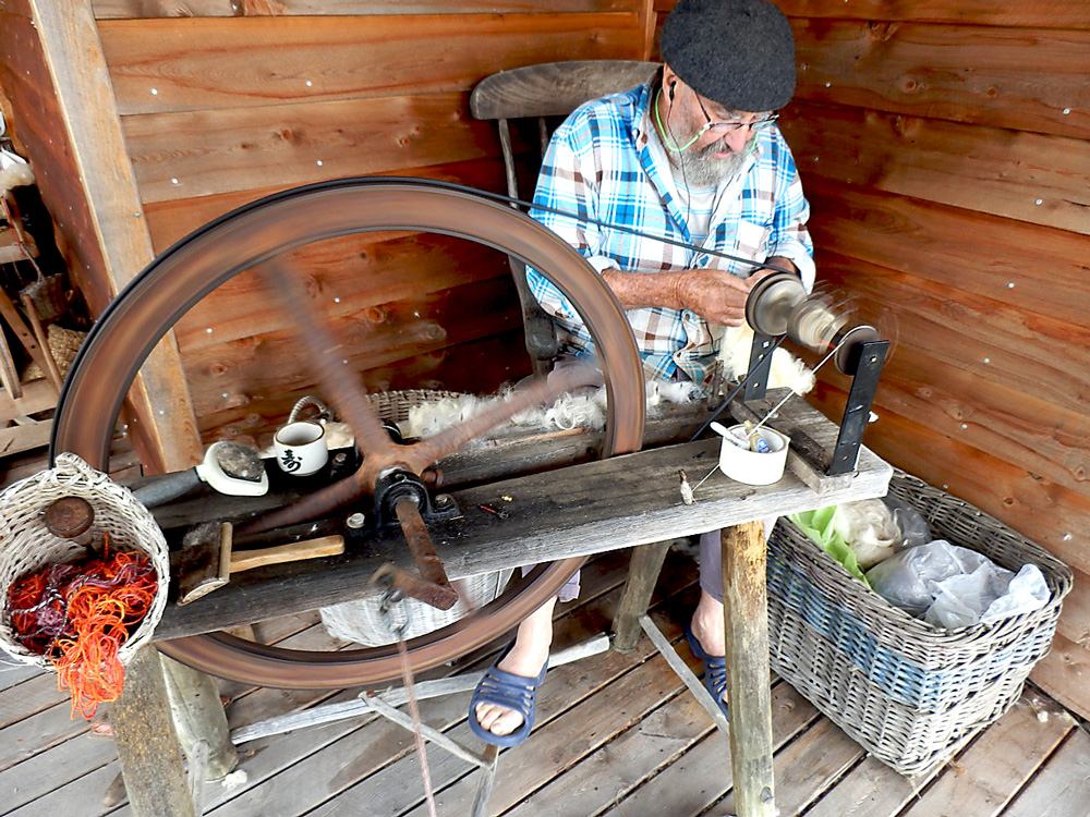 Bob spinning fleece on a great wheel.