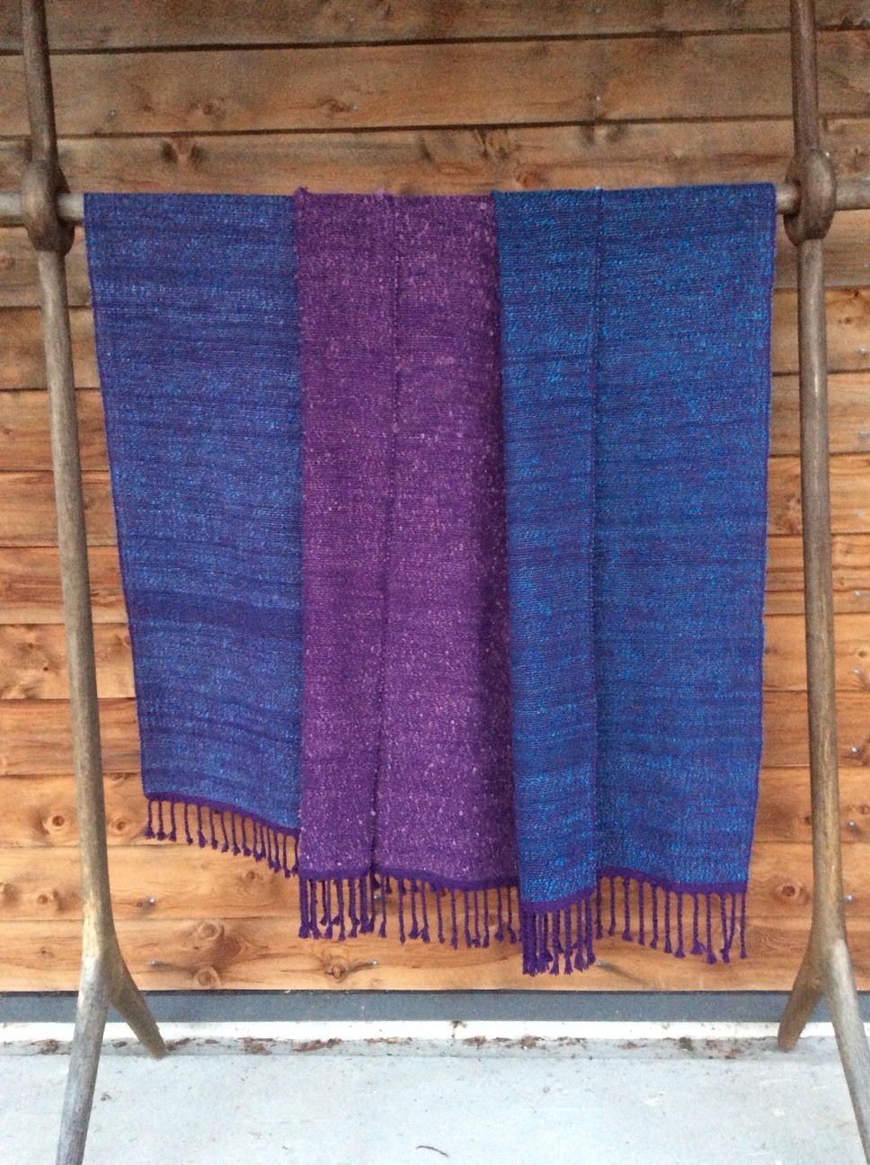 Soft wraps in blue and violet, with twisted fringes.